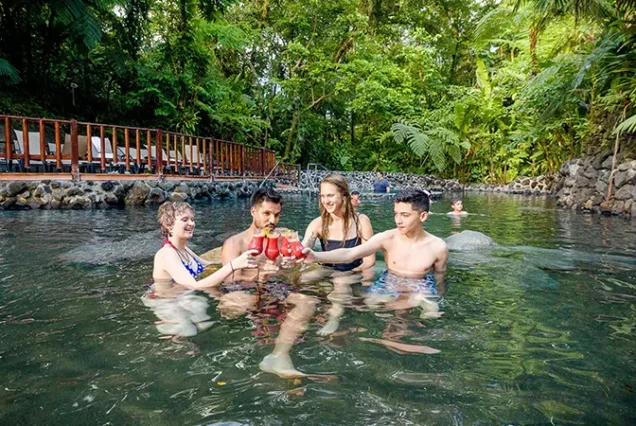 Family enjoying Costa Rica volcanic hot springs in La Fortuna, Arenal