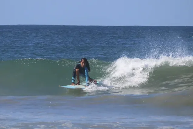 Surfer riding a wave on Costa Rica's Pacific coast in Guanacaste